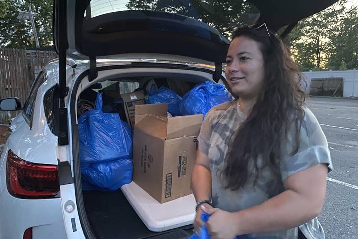 Laura Bustamante, policy and campaign manager with the New Jersey Alliance for Immigrant Justice, sorts through the welcome bags of food, diapers and hygiene products organizers brought to Teterboro Airport, where a plane rumored to be full of migrants from Texas was scheduled to arrive.